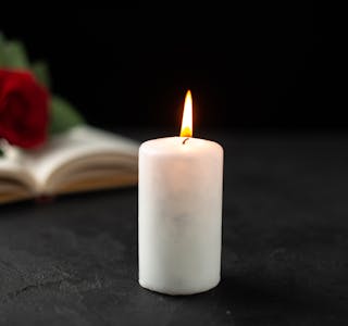 front-view-red-rose-with-open-book-candle-black