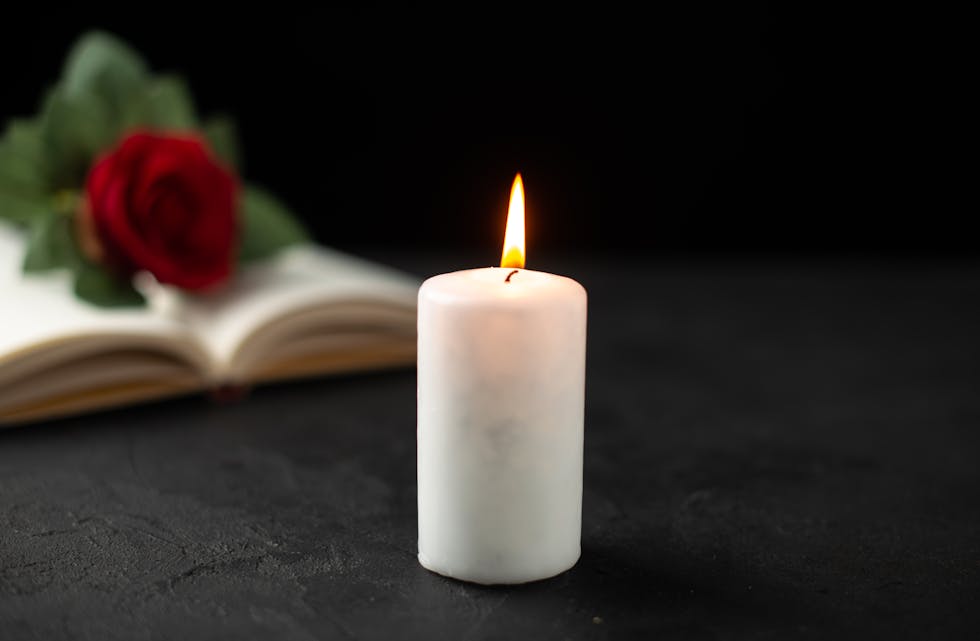 front-view-red-rose-with-open-book-candle-black